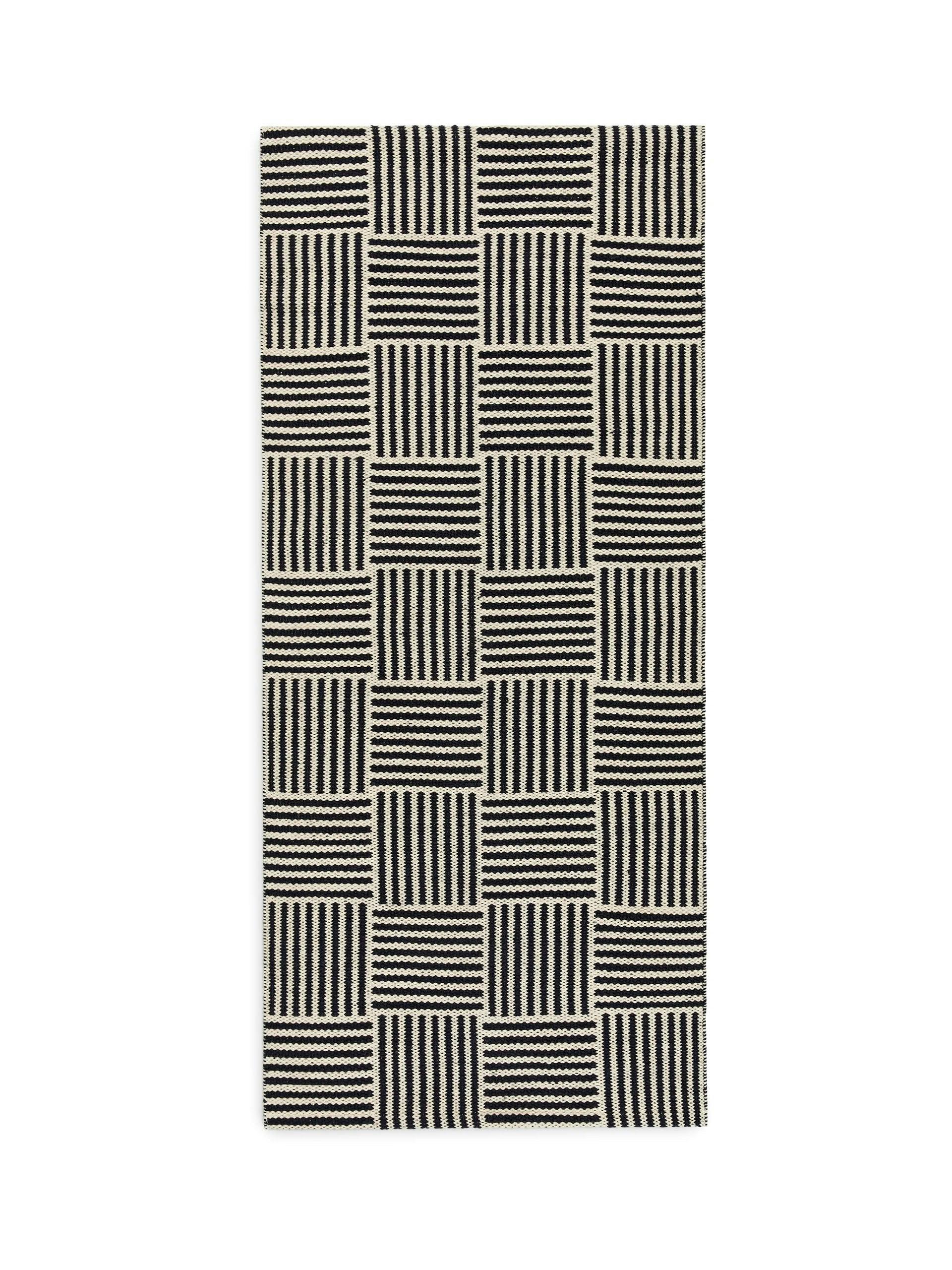 Woven cotton and wool rug in black and off-white