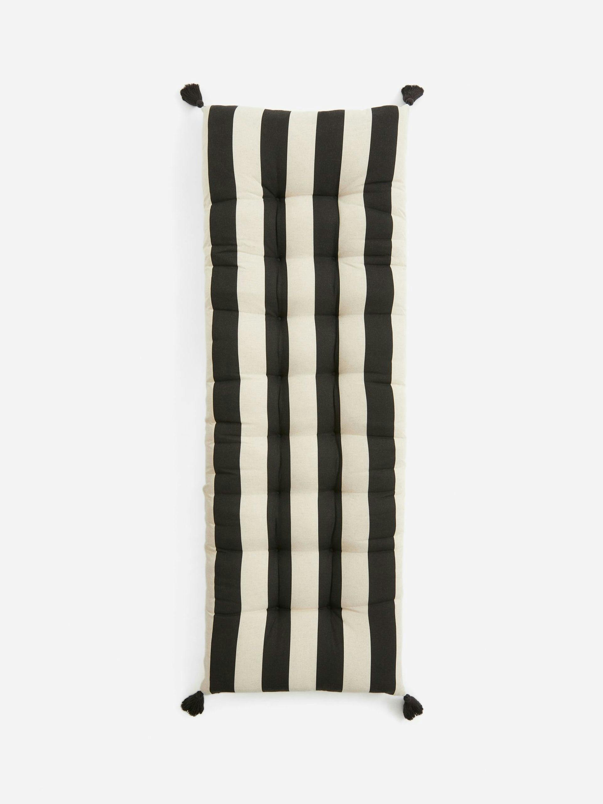 Black and white striped tasselled cushion