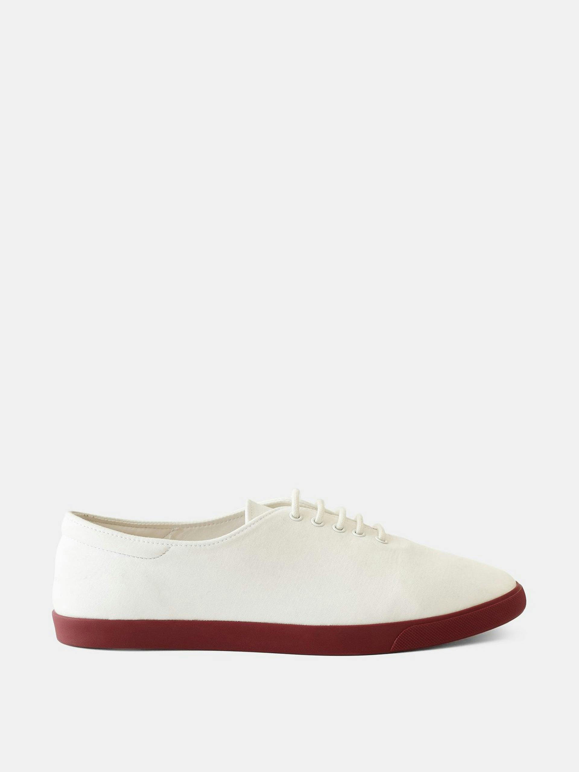 White canvas trainers with burgundy sole