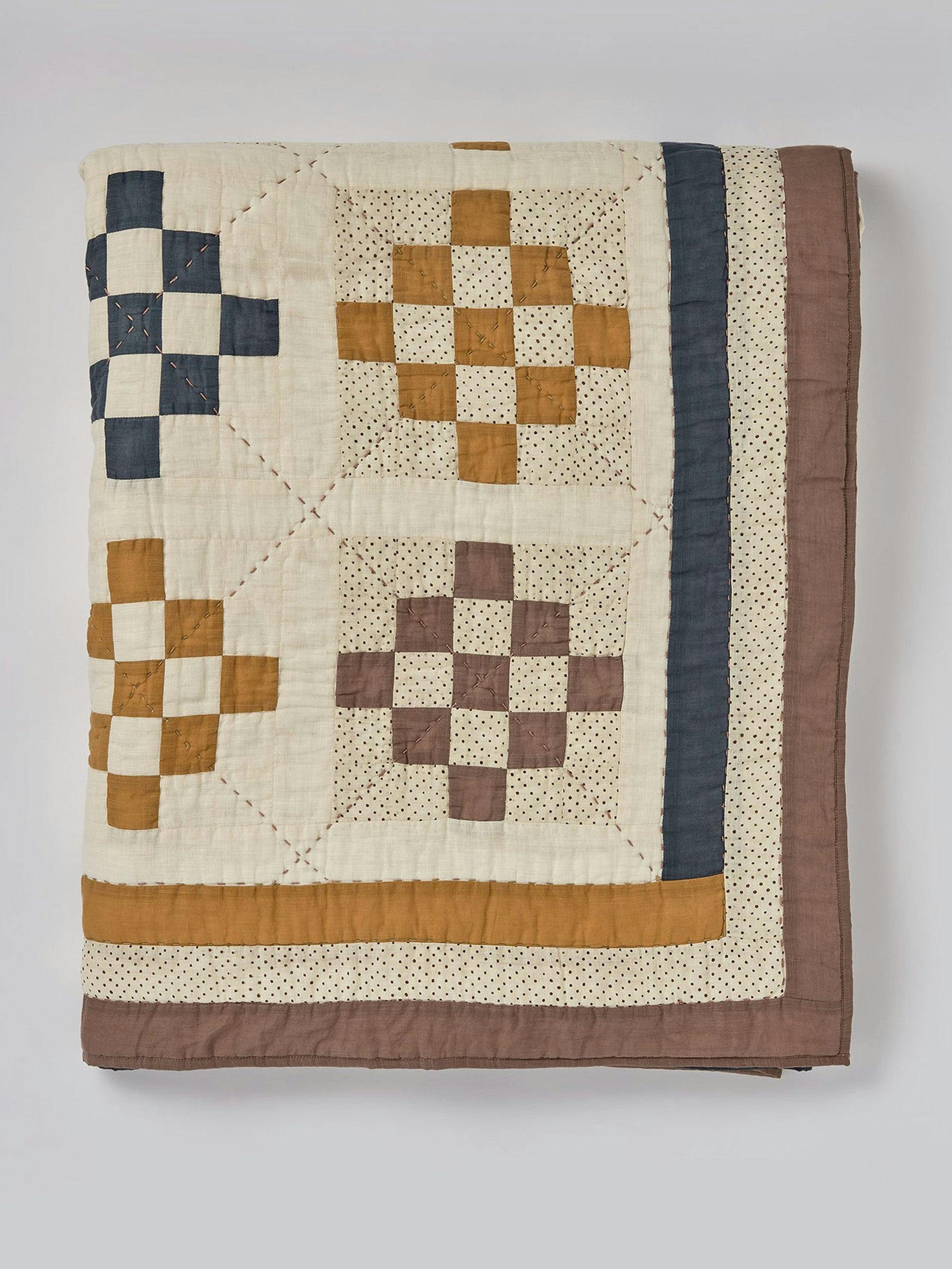 Hand-stitched cotton patchwork quilt