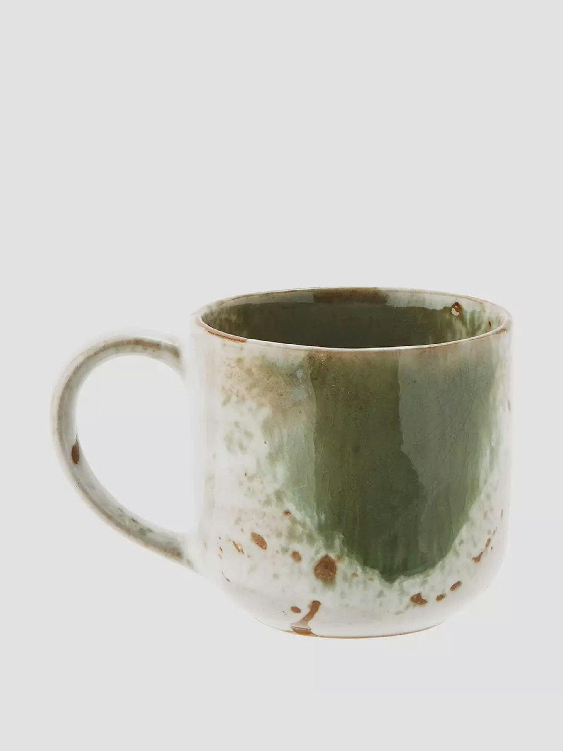 Green and white glazed mug