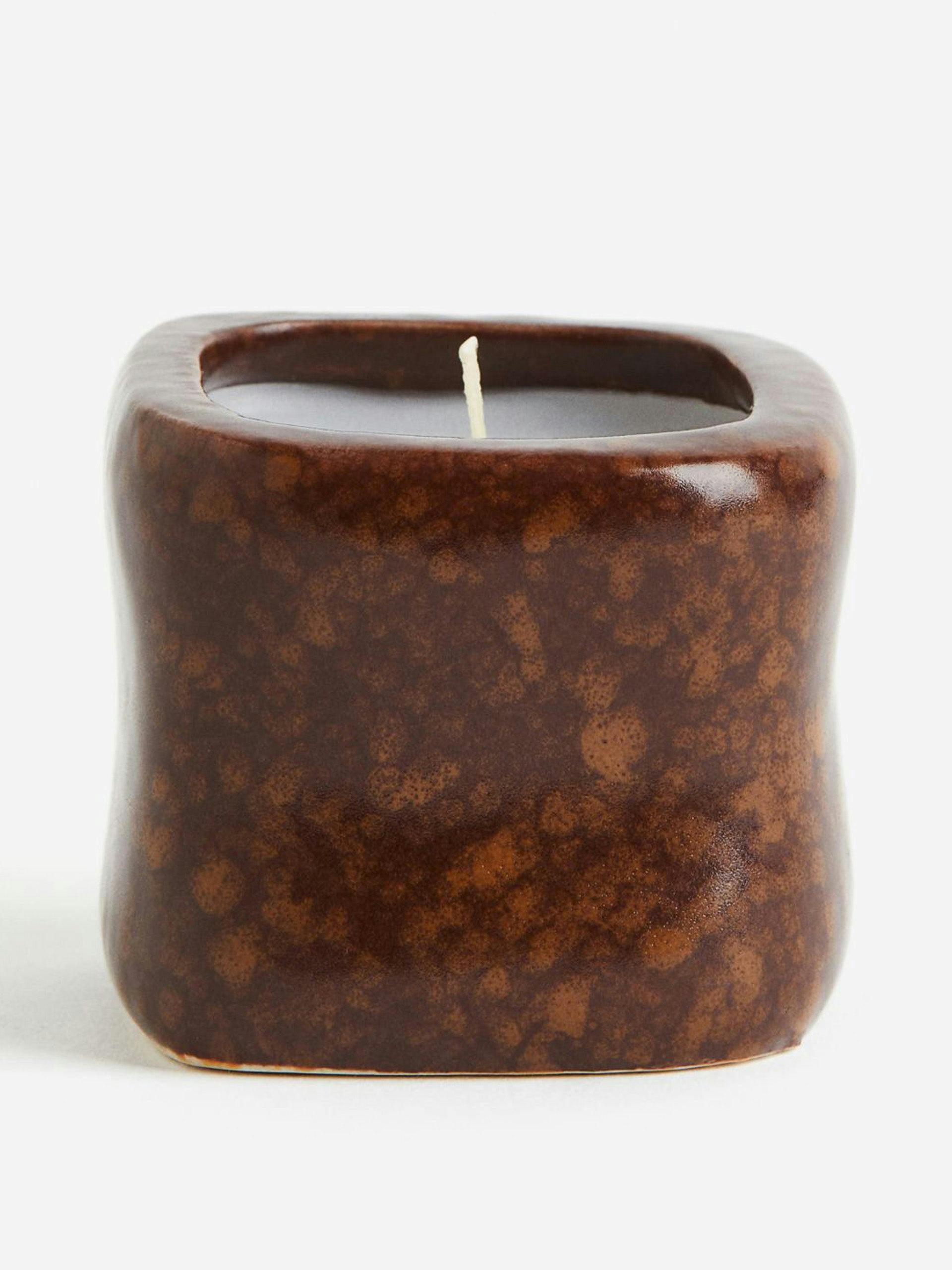 Scented candle in a ceramic holder