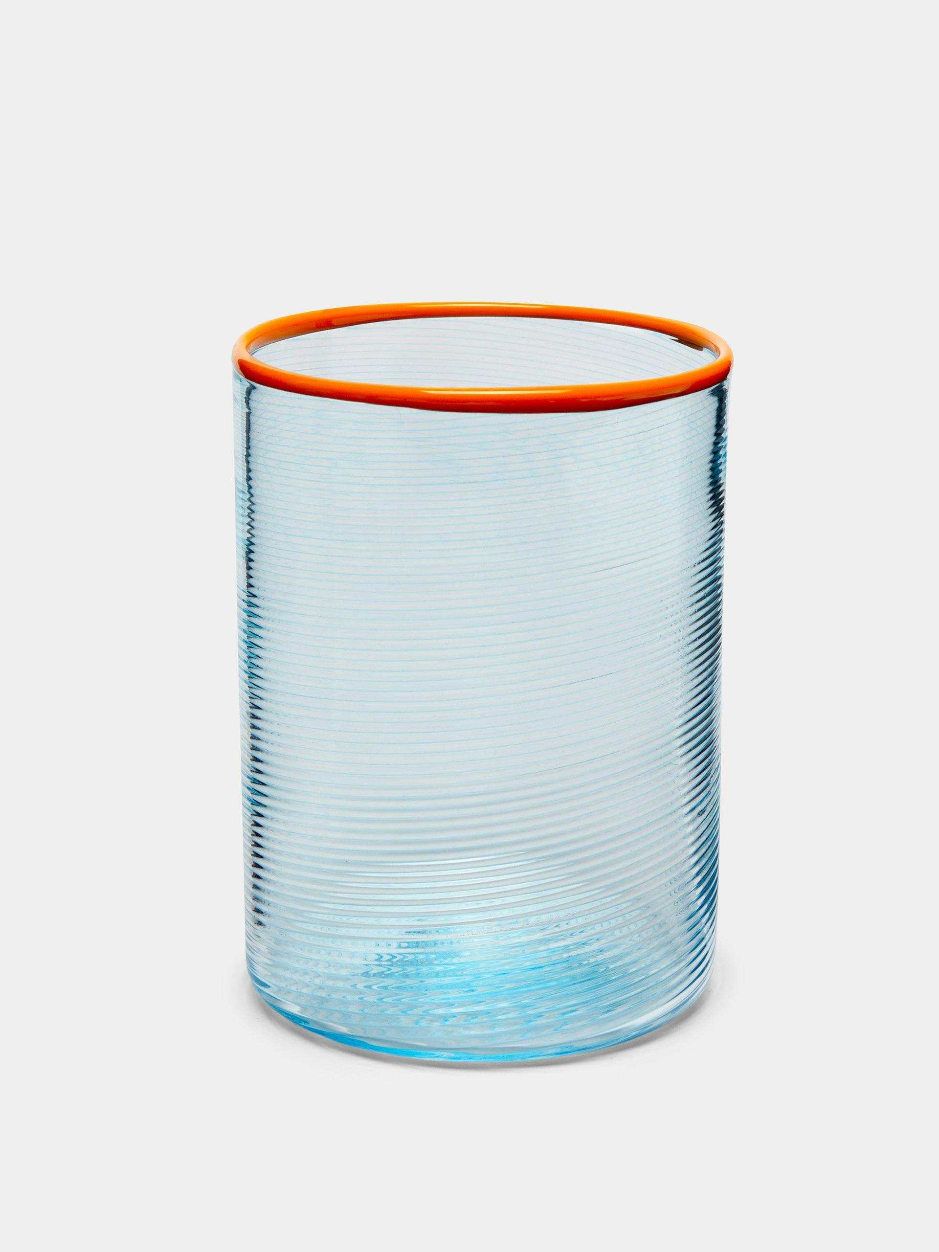 Glass tumbler with orange rim