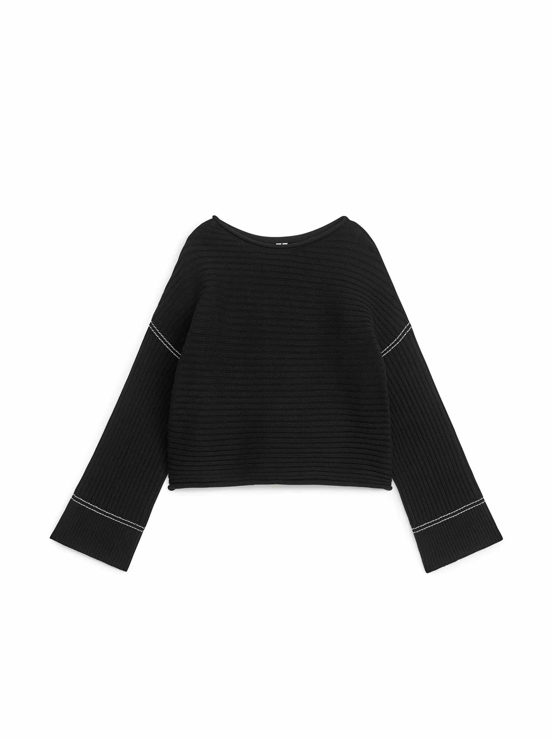 Black jumper with white stitching
