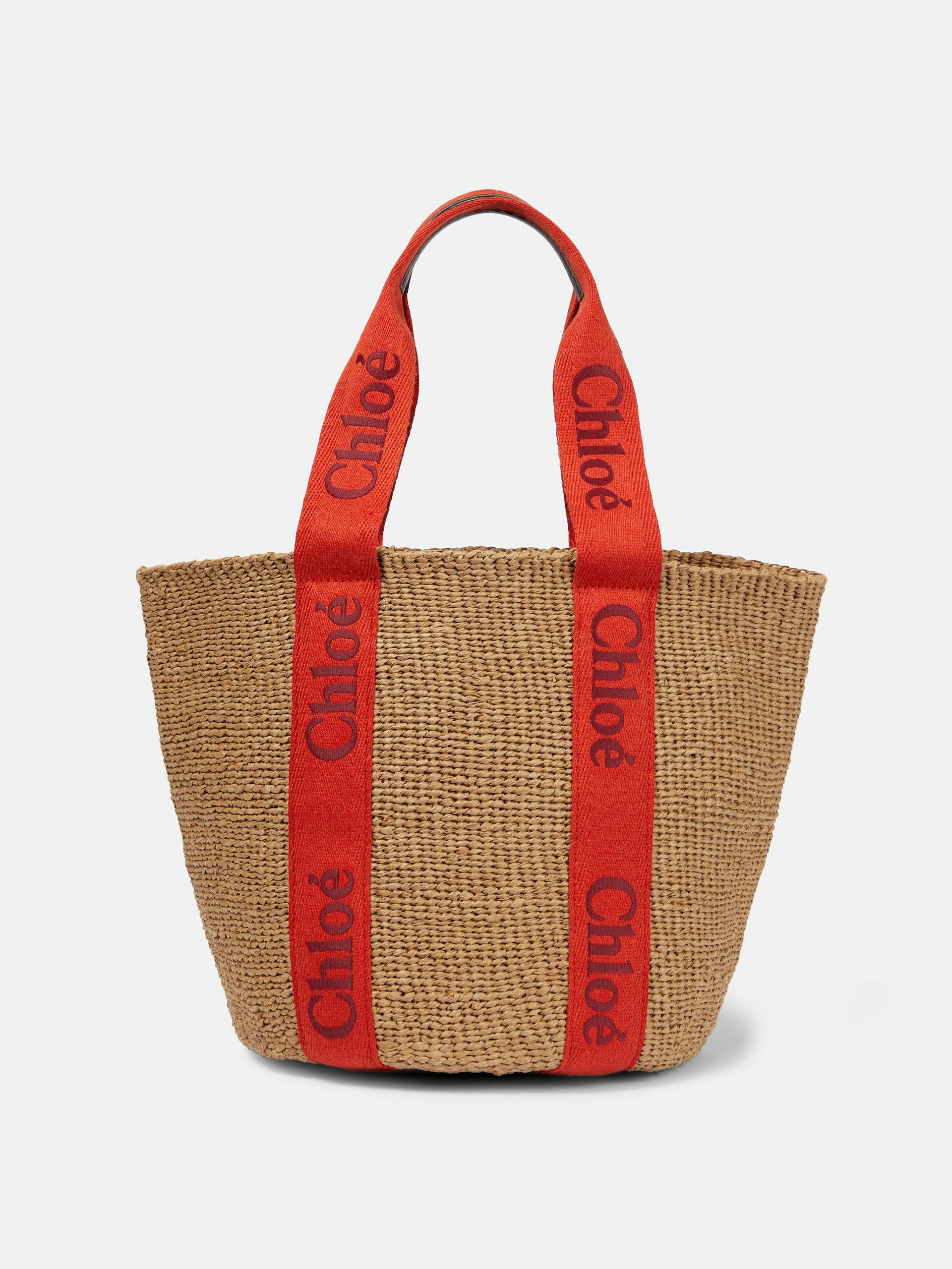 Raffia basket bag with red logo canvas straps