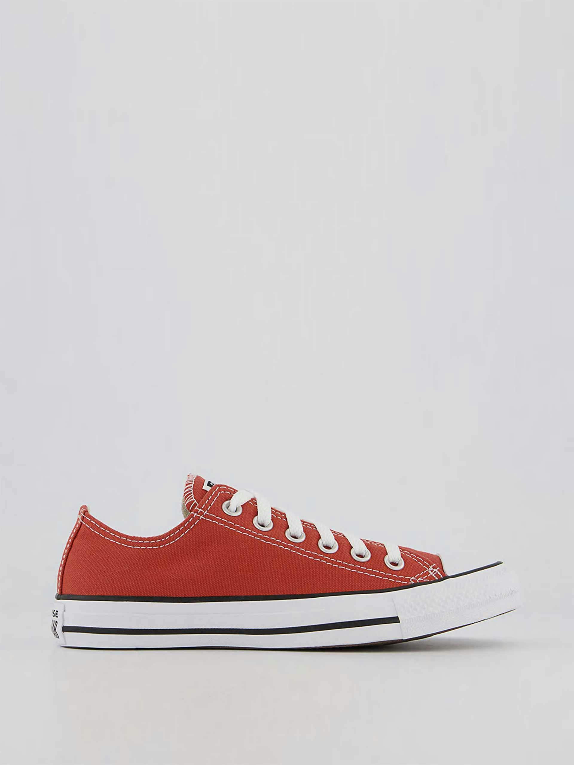 Red low top trainers